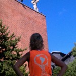 jordan sporting her tank top on the streets of Belgium, with Atlas looking down with pride